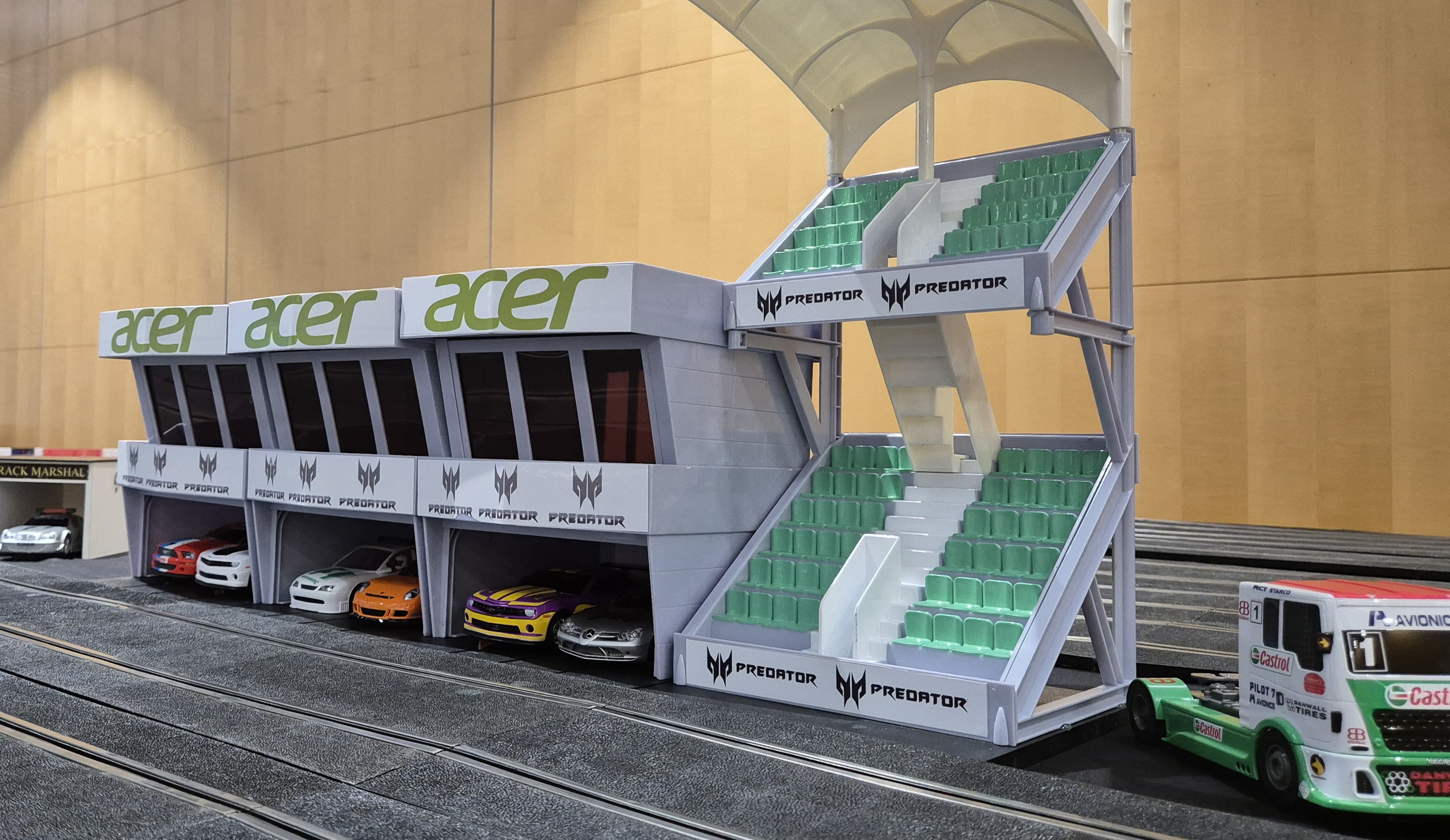 Branded Acer Predator grandstand and pit garage trackside feature with racing cars