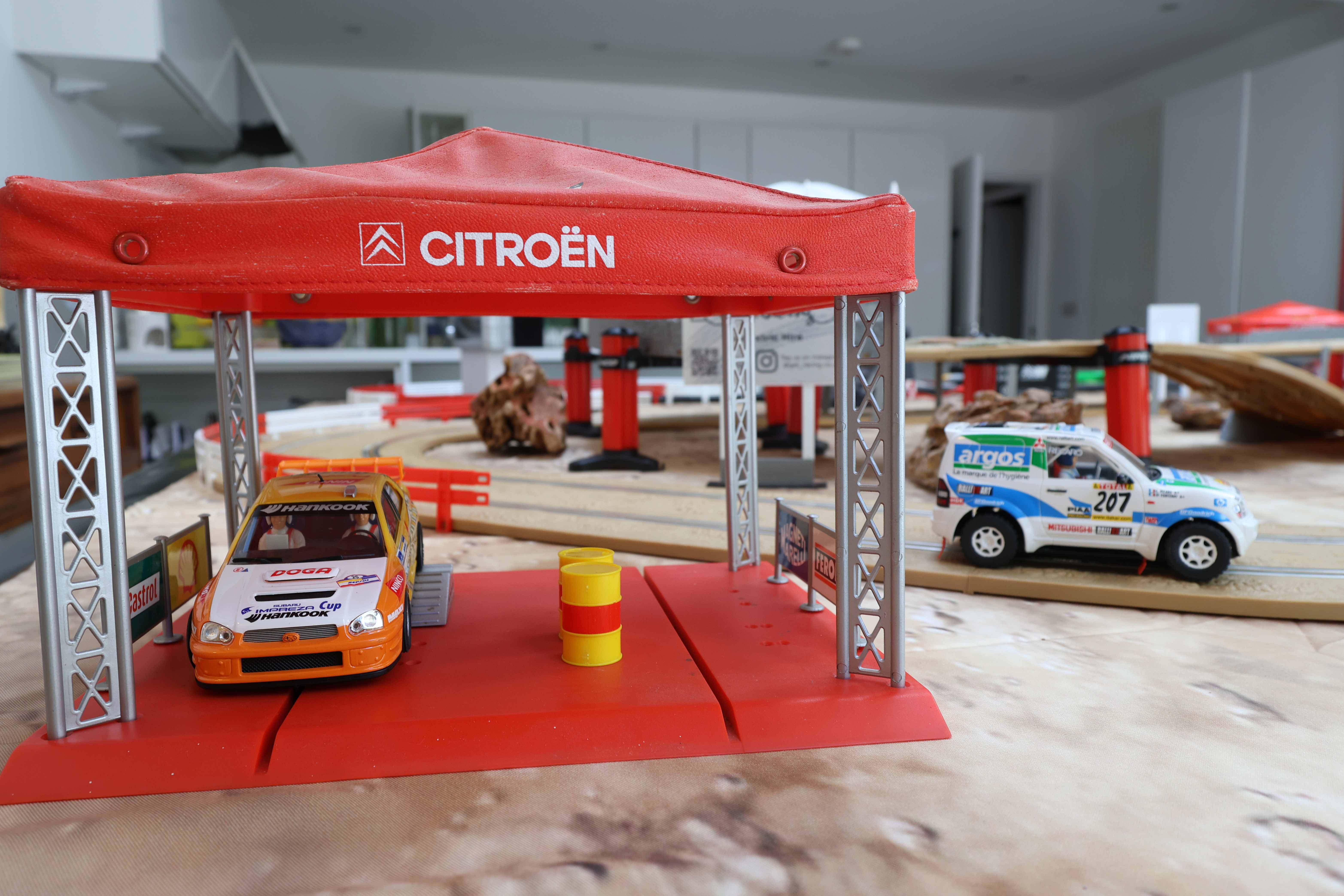 Close up of the off-road Scalextric pit garage with Citroen gazebo and rally cars